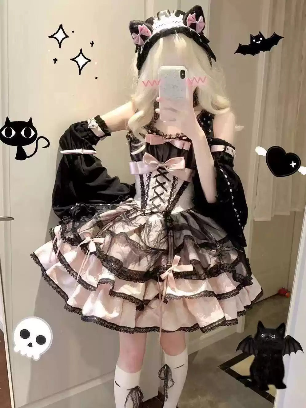Person wearing a black and white Lolita outfit with cat ears, standing in a room.