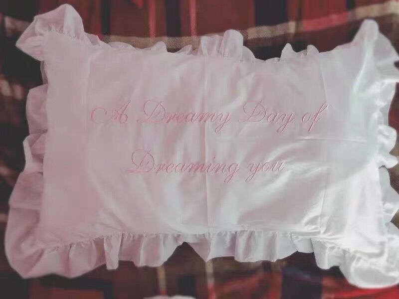 ruffled white embroidered cotton pillowcase