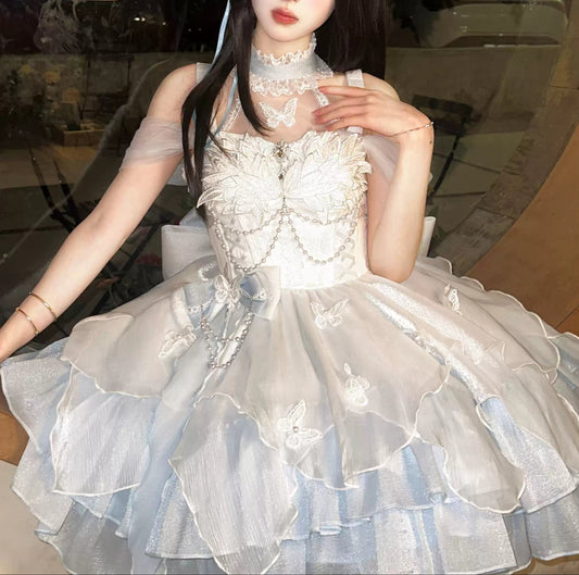 Person wearing a white lace dress with a decorative headpiece indoors.